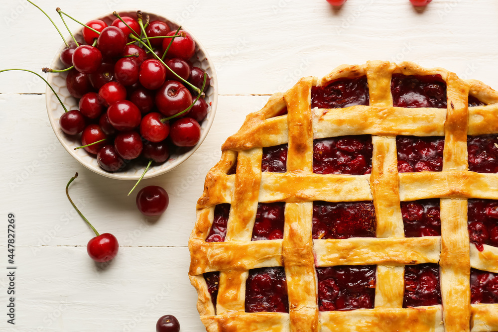Tasty cherry pie on light wooden background