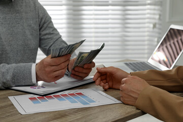 Wall Mural - Cashier giving money to businesswoman at desk in bank, closeup