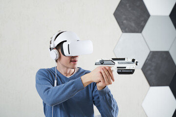 Wall Mural - man with virtual reality headset and blaster is playing game.