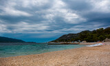 Fototapeta Morze - Dark stormy clouds gather above a popular windsurfing beach in Peljesac, Croatia