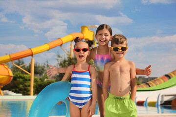 Sticker - Cute little children with inflatable ring near pool in water park