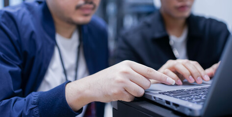 close up senior programmer hand teach employee trainee on keyboard  laptop to input code language into software system during suggest at office for educational technology	