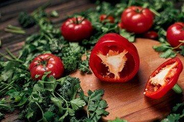 sliced sweet paprika and fresh tomatoes on a wooden board.