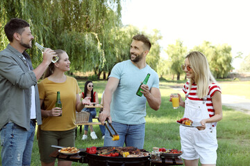 Canvas Print - Group of friends having barbecue party in park