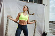 © Jacob Lund - Fitness woman with battle rope