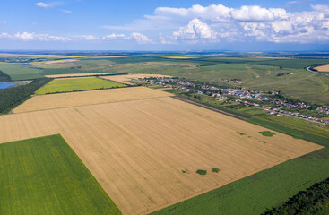 Wall Mural - Northern Caucasus rural landscape. Aerial view of Etoko village and surrounding fields on sunny summer day. Kabardino-Balkaria, Caucasus, Russia.