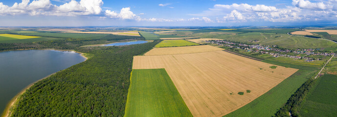 Wall Mural - Panoramic aerial view of Tambukan salt lake, Etoko village and surrounding fields on sunny summer day. Kabardino-Balkaria, Caucasus, Russia.