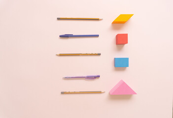 Creative concept of colorful, trendy, bright geometrical shape objects and school supplies. Flat lay.