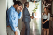 © Dragana Gordic - Photo of male Worker having headache. Dark-haired office worker having headache after been fired from work for no reason. Stressed employee intern suffering from gender discrimination