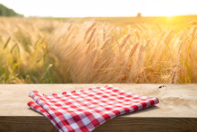 Wooden Board Table In Front Of Wheat Field On Sunset Light. Ready For Product Display Montages