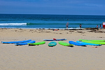 Wall Mural - Surfboards on the Beach with Waves in the Background