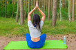 © ARVD73 - Woman meditating relaxing lotus yoga pose. Healthy lifestyle concept.summer forest.Back view.
