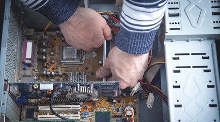 Wall Mural - Repairman trying to repair computer. Repair. Service