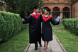 © Тарас Нагирняк - Two gradute friends in graduation robes walking in university campus