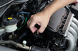 Car technician man use screwdriver remove bolt in engine room service and maintenance concept