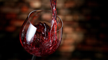 Fototapete - Freeze motion of red wine pouring into glass.