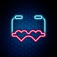 Sticker - Glowing neon line Heart shaped love glasses icon isolated on brick wall background. Suitable for Valentine day card design. Colorful outline concept. Vector