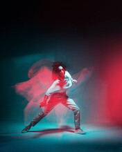 Contemporary Hip Hop Dance. Cool Dancing Modern Girl Moving In Colorful Neon Studio Light. Long Exposure. Copy Space.