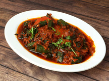 Indian Style Bhindi Masala Or Okra Curry Also Known As Ladyfinger, Served Over A Rustic Wooden Table, Selective Focus