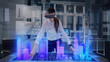 © Iokanan Pro - Female Architect wearing Augmented Reality Lenses makes gestures and redesigns 3D City Model. High Tech Office use Virtual Reality Holographic Modeling Software Application.