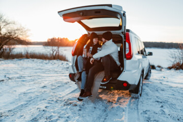 Wall Mural - couple near car at winter sunset