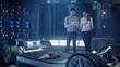 © Iokanan Pro - Mockup of Electric Vehicle: Automotive Professional Engineers working on design of Electric Car using Futuristic Transparent Touchscreen Tablets. High-tech facility. Electric car chassis.