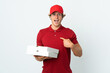 © luismolinero - pizza delivery man over isolated white background with surprise facial expression