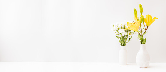 Wall Mural - home interior with decor elements. yellow lilies in a vase on a light background