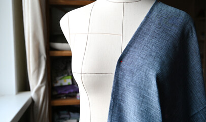 Wall Mural - Tailoring and clothes making concept. Tailor's mannequin with cloth on it. Home studio, handmade clothes