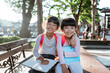 © Odua Images - smiling two young little girl student holding book