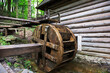 An old water mill. Blurred forest background.