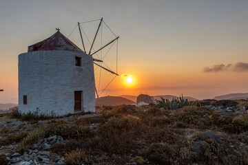 scenic golden hour view of a traditional wind mill in Chora Amorgos  Greece