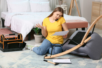 Wall Mural - Young woman assembling furniture at home