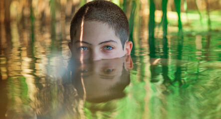 13 years Teenage boy swimming in lake, Children lifestyle. Enjoy the life