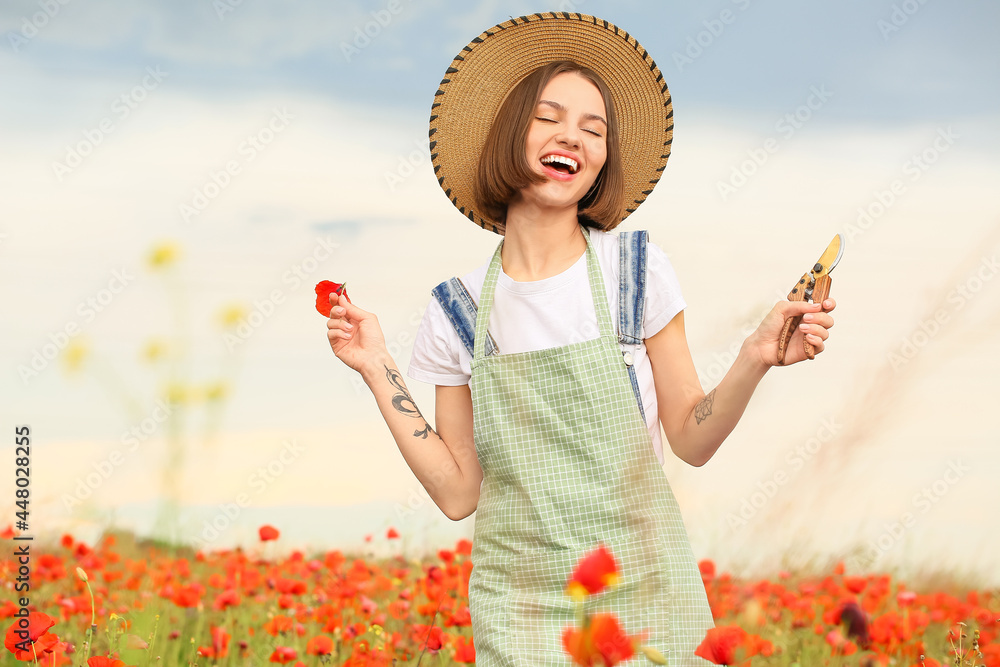 Beautiful female farmer in poppy field