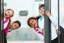 Cute Little Pupils Near School Entrance Outdoors
