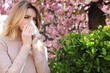 © New Africa - Woman suffering from seasonal pollen allergy outdoors