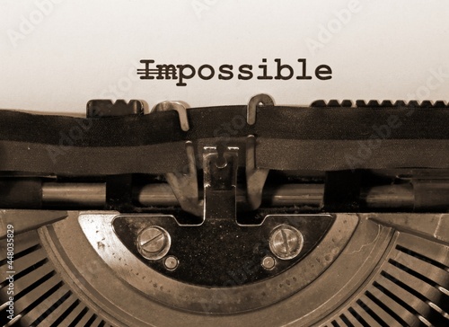 WORD IMPOSSIBLE with the text IM deleted and then everything is possible written with the typewriter
