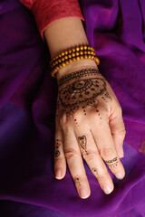 Wall Mural - Woman with beautiful henna tattoo on hand, closeup. Traditional mehndi