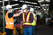 © NVB Stocker - Temperature measurement with employee temperature meter before entering work at factory. Professional diversity engineering team. Worker wearing face mask prevent covid-19 virus