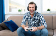 © Proxima Studio - Man playing games on console, gamepad in hands