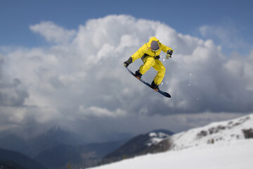 Wall Mural - Snowboarder jumping in the mountains, extreme winter sport.