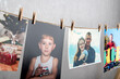 © somemeans - Family photo cards hang with clothespins on rope. Memories. Home photo gallery, original photo exhibition. Best moments