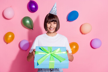 Canvas Print - Portrait of attractive cheerful girl holding in hands festal giftbox air balls flying isolated over pink pastel color background