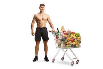 Poster - Shirtless muscular man with a shopping cart full of food