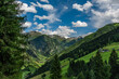 Summer valley with Grossarler Ache small river and blue cloudy sky