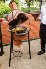 photo of the traditional cooking of tagine on coals. Moroccan cuisine