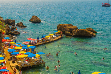 Wall Mural - ANTALYA, TURKEY: Colorful umbrellas on Mermerli beach in the center of Antalya.