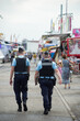 © pixarno - Mulhouse - France - 30 July 2021 - Portrait on back view of french national gendarmes patrolling at the fun fair during the covid-19 pandemic