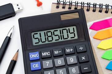 Business concept. calculator, and financial documents in the center inscription -SUBSIDY